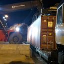 Loading containers at Southampton Docks Nighttime view of reachstacker placing container on train