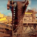 Quarry conveyor flow of granite chips seen from head on