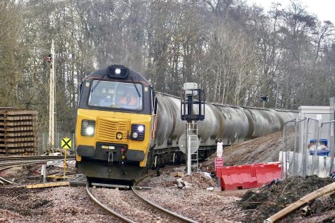 Heavy tanker train leans into curve leaving Perth