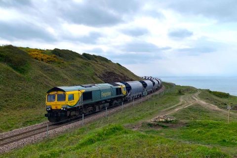 Freight train on the Boulby Mine branch at cliffs near Saltburn with the sea in background