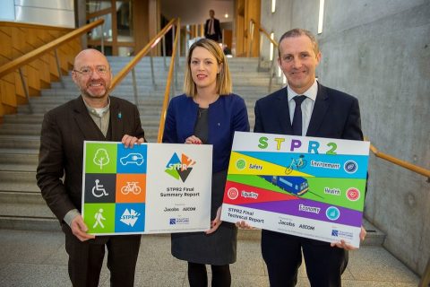 Politicians show off transport document on the steps of Holyrood Parliament building