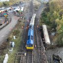 Locomotive towing away cement trucks from Carlisle derailment