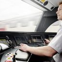 Train driver in cab at the controls