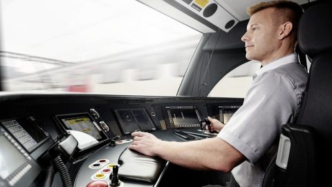 Train driver in cab at the controls