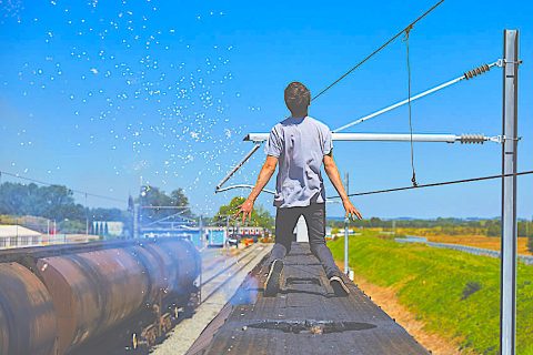 Staged image of trespassing male youth suffering electrocution on the roof of a rail vehicle