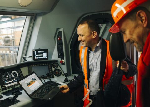 Driver and colleague in the cab of railway engine