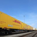 DHL container train against a blue sky