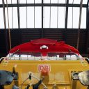 Buffer level shot of a DB Cargo UK class 66 locomotive looking right up the nose towards the cab windows, almost as through one was under the wheels