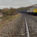 DC Rail train with two class 56 diesels at the head hauling an aggregates train over the tracks at Dronfield
