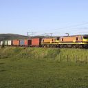 Freightliner double headed electric locomotives hauling intermodal train in countryside