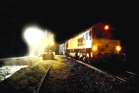 An HS2 freight train at night is one of 15,000 such trains supporting the construction project over its ten year lifespan