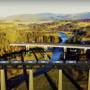 Tesco train on the Highland Main Line crossing a bridge with the A9 in background